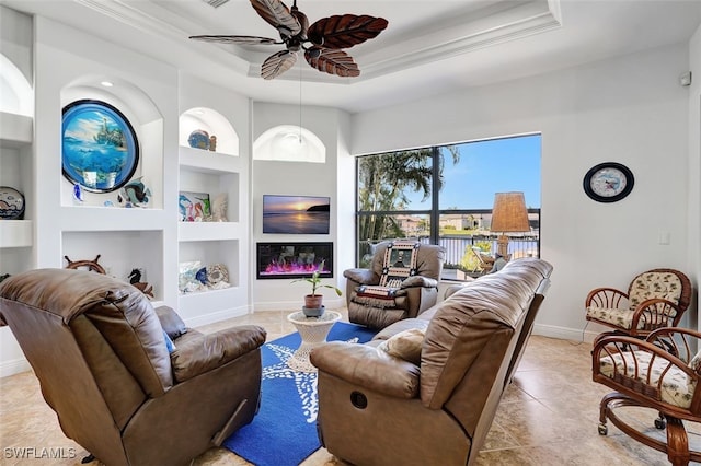 living room with light tile patterned floors, built in features, ceiling fan, and ornamental molding