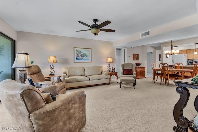 living room featuring ceiling fan with notable chandelier and carpet floors