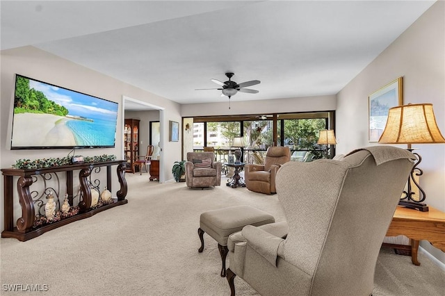 living room with ceiling fan and carpet