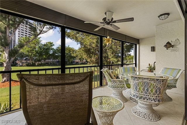 sunroom / solarium featuring ceiling fan and a healthy amount of sunlight