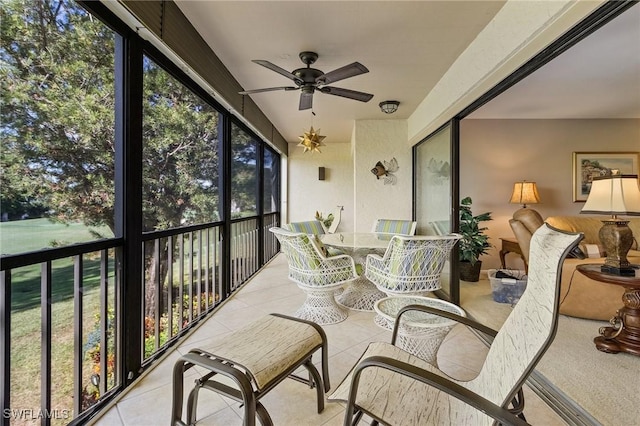 sunroom / solarium featuring ceiling fan