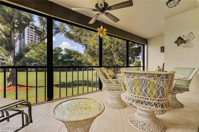 sunroom / solarium featuring ceiling fan