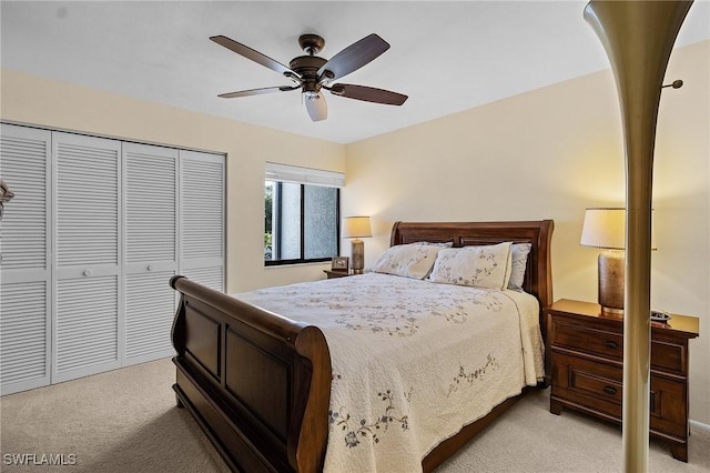 carpeted bedroom with ceiling fan and a closet