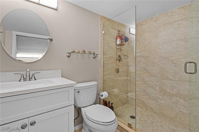 bathroom featuring toilet, vanity, and walk in shower