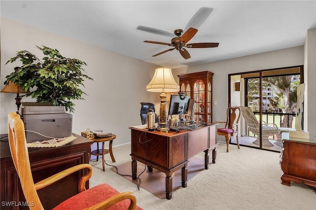 office space featuring ceiling fan and light colored carpet