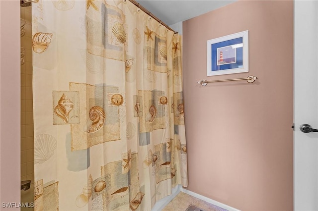 bathroom featuring a shower with shower curtain and tile patterned floors