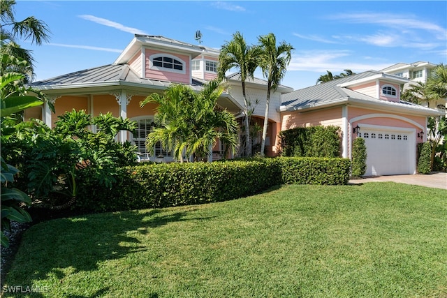 view of front facade with a garage and a front lawn