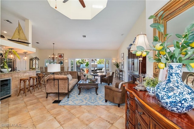 living room featuring vaulted ceiling and ceiling fan with notable chandelier