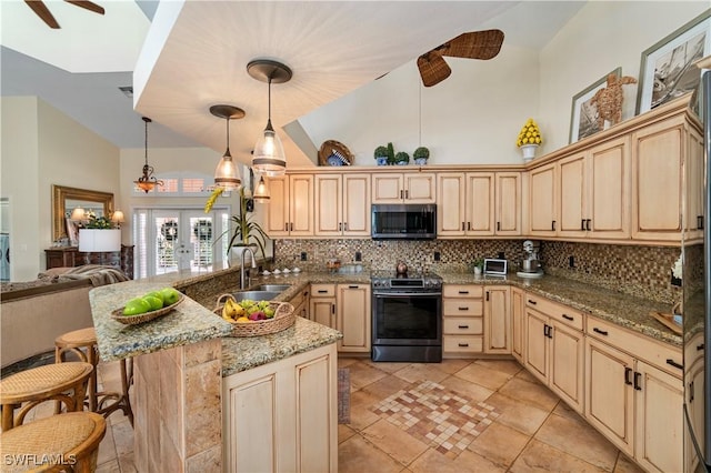 kitchen with stainless steel appliances, a kitchen breakfast bar, light stone counters, backsplash, and decorative light fixtures