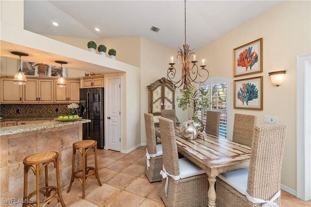 dining space featuring a notable chandelier and high vaulted ceiling