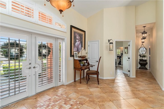 entryway featuring french doors and a towering ceiling