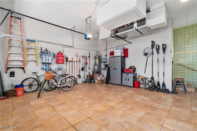 garage featuring a garage door opener and water heater