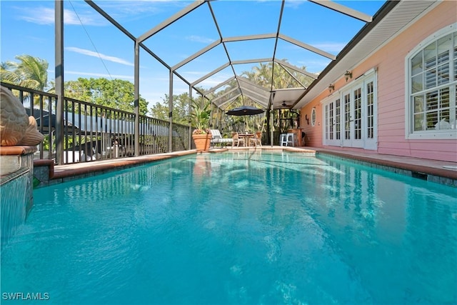 view of pool featuring glass enclosure and french doors