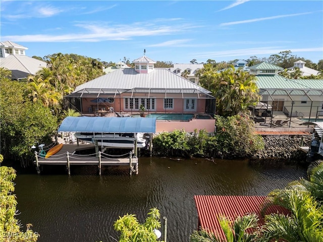 view of dock with a water view and a patio area