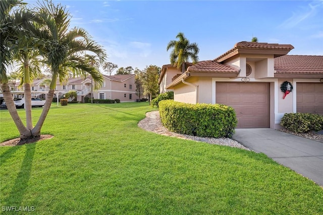 view of front of house with a front yard and a garage