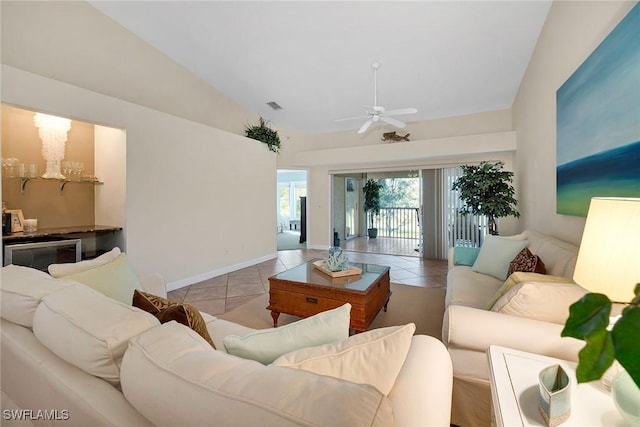 living room with light tile patterned floors, ceiling fan, and lofted ceiling