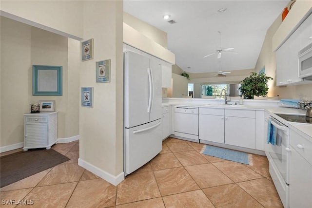 kitchen featuring white appliances, ceiling fan, sink, white cabinets, and lofted ceiling