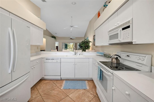 kitchen featuring white cabinetry, sink, ceiling fan, vaulted ceiling, and white appliances