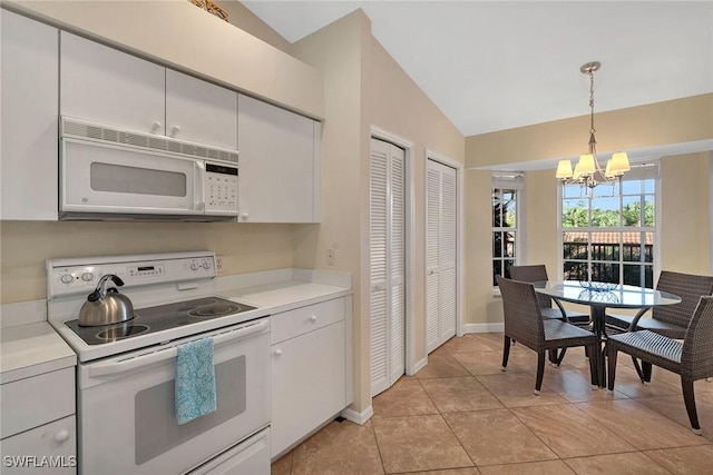 kitchen with white appliances, vaulted ceiling, decorative light fixtures, an inviting chandelier, and white cabinets