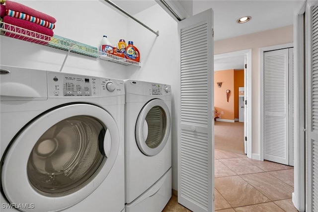 washroom featuring separate washer and dryer and light tile patterned floors