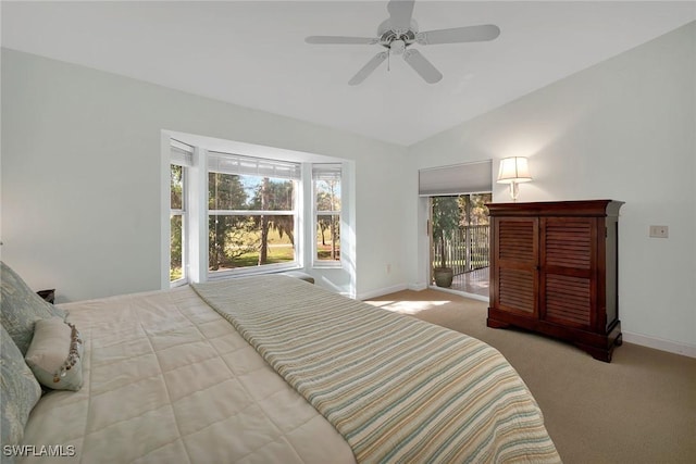 carpeted bedroom featuring ceiling fan, access to outside, and vaulted ceiling