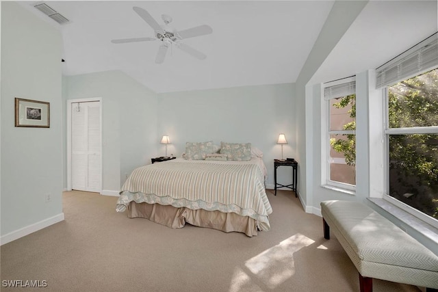 bedroom featuring a closet, light colored carpet, ceiling fan, and lofted ceiling