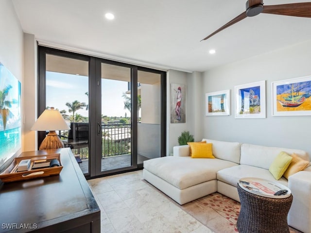 living room featuring ceiling fan and floor to ceiling windows