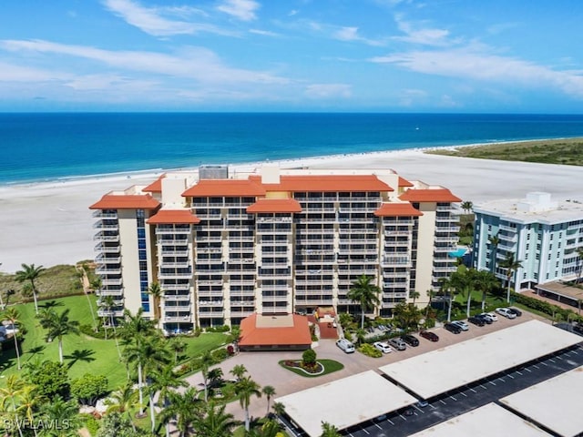 exterior space featuring a water view and a beach view