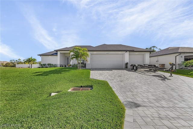 view of front of property featuring a garage and a front lawn