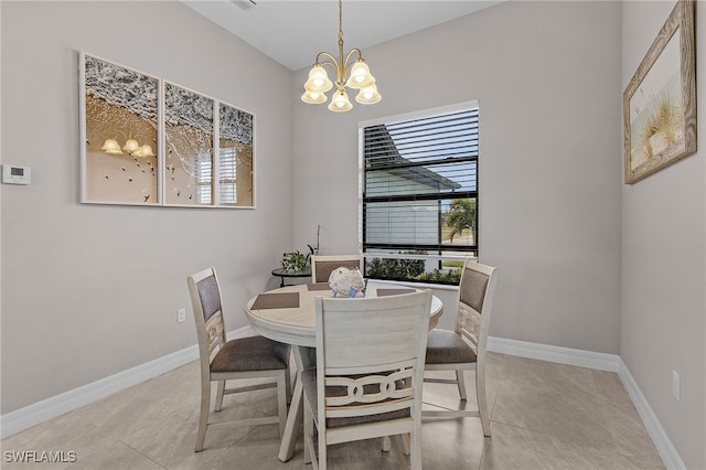 dining space featuring light tile patterned floors and an inviting chandelier