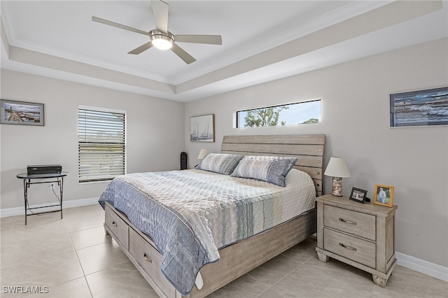 bedroom with a tray ceiling, ceiling fan, and ornamental molding