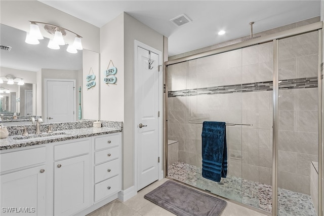 bathroom with tile patterned flooring, vanity, and an enclosed shower