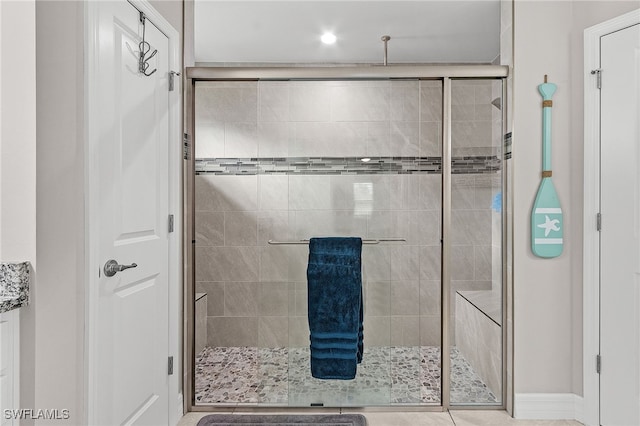 bathroom with a shower with shower door