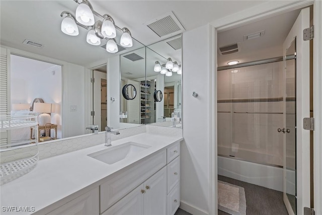 bathroom featuring shower / bath combination with glass door and vanity