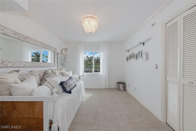 bedroom featuring light colored carpet, ornamental molding, and a chandelier