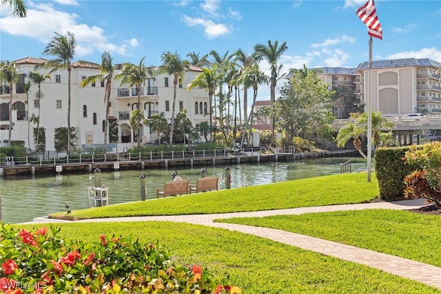 view of community with a lawn and a water view