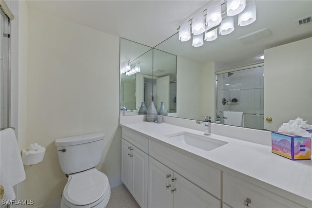 bathroom with vanity, an enclosed shower, and toilet