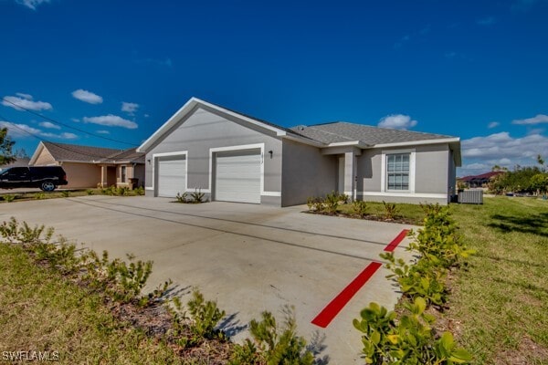 ranch-style home with a front yard, a garage, and cooling unit