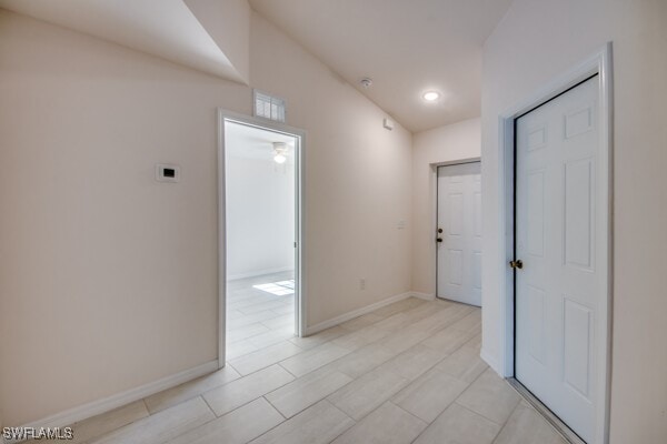 hallway featuring lofted ceiling