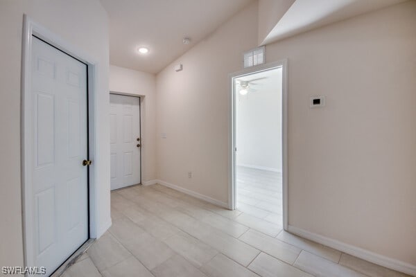 hall with light tile patterned floors