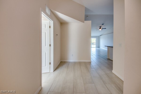 hallway with light hardwood / wood-style floors