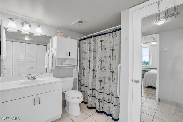 bathroom with tile patterned floors, vanity, curtained shower, and toilet