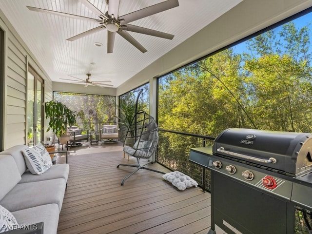 sunroom / solarium featuring ceiling fan