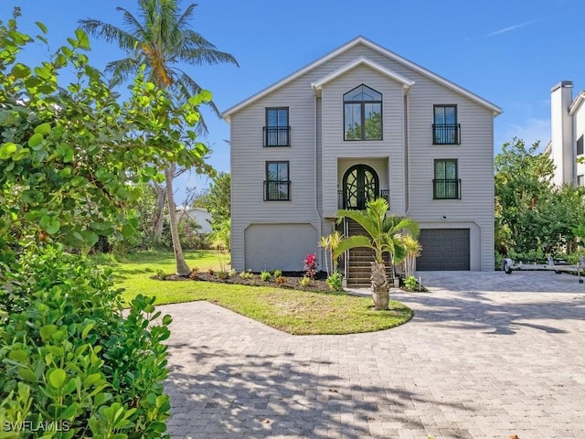 view of front of property with a garage and a front yard