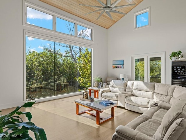 living room featuring wood ceiling, a high ceiling, and light wood-type flooring