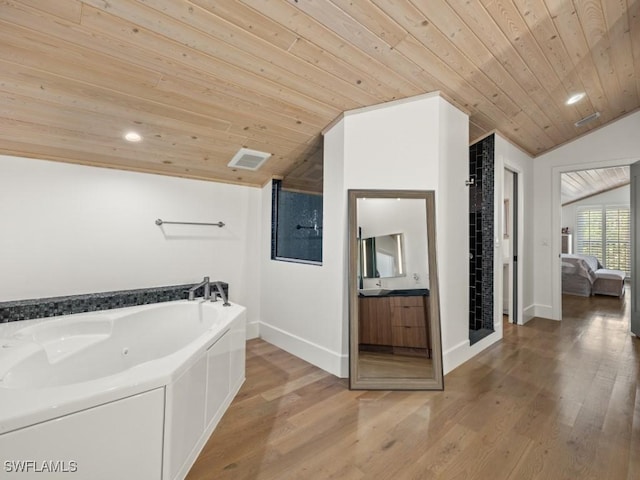 bathroom featuring lofted ceiling, a bathtub, wooden ceiling, and vanity