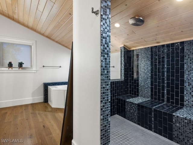 bathroom with hardwood / wood-style floors, lofted ceiling, tiled shower, toilet, and wood ceiling