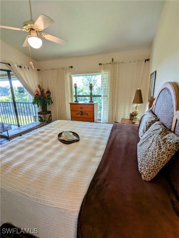 bedroom with ceiling fan, multiple windows, and access to outside