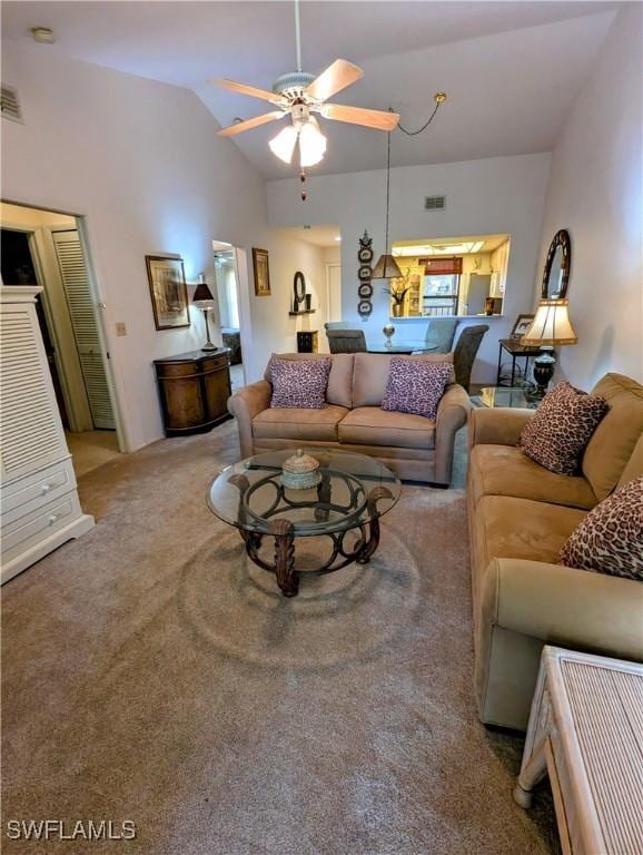 carpeted living area featuring a ceiling fan, lofted ceiling, and visible vents