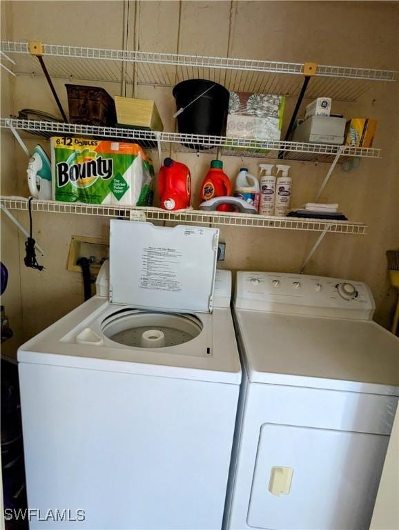 clothes washing area featuring washing machine and clothes dryer